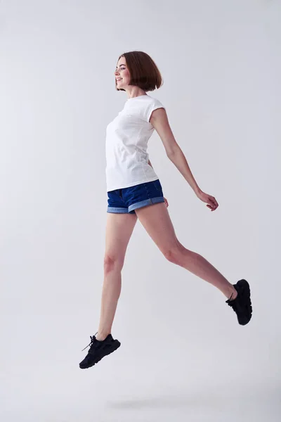 Beautiful female jumping while posing — Stock Photo, Image