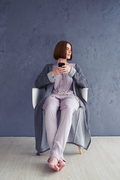 Nice girl postponing using smartphone — Stock Photo, Image