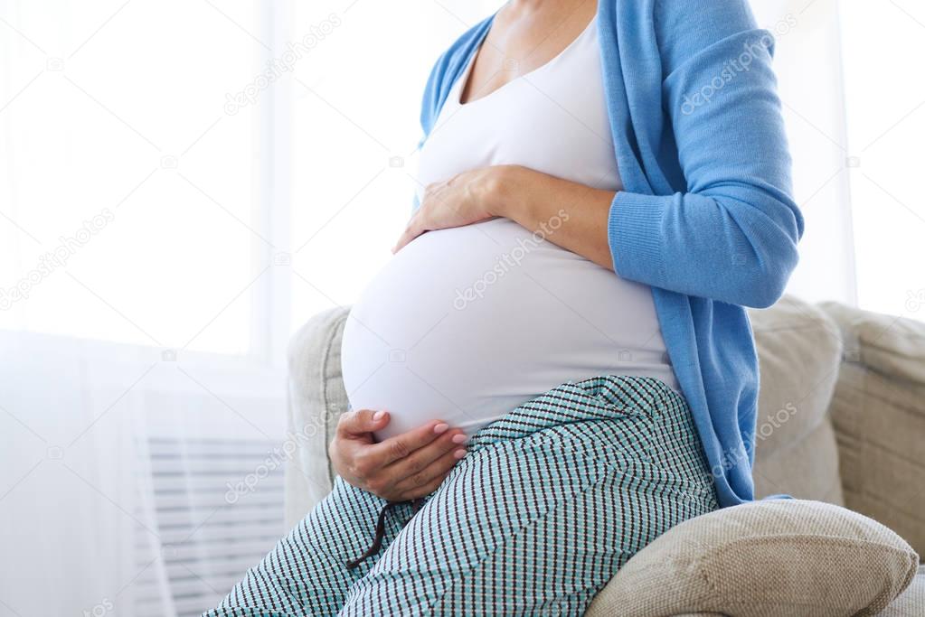 Hands fugging pregnant belly