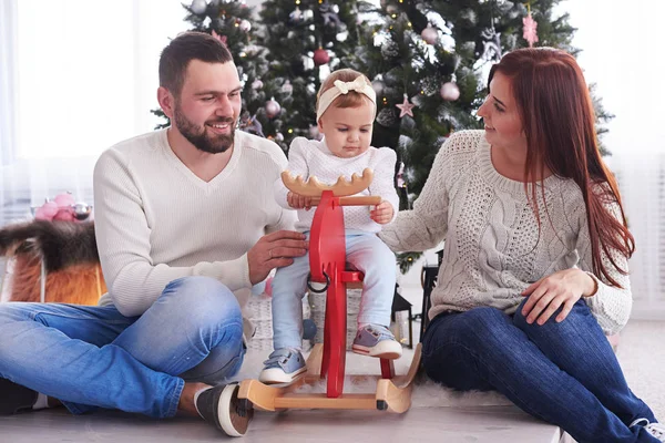 Stylish family celebrating christmas in room near christmas tree — Stock Photo, Image