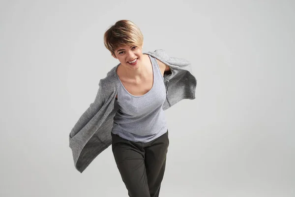 Girl with short haircut in the flowing cardigan posing at studio — Stock Photo, Image