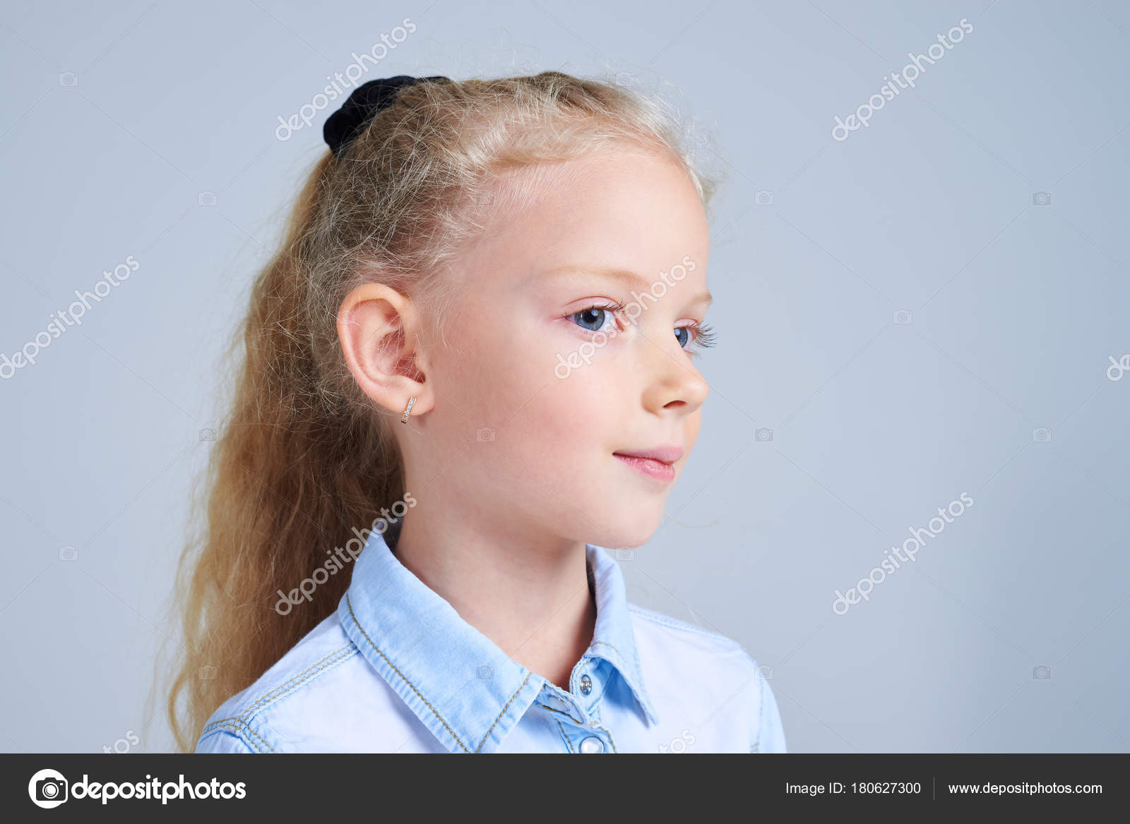 Cute Blonde Girl With Blue Eyes Posing At Studio Stock Photo