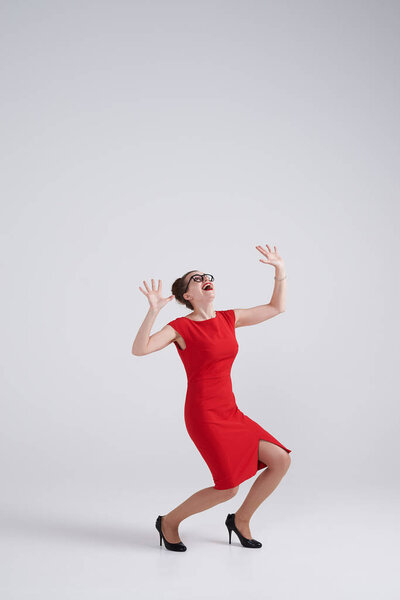 Scared businesswoman getting crushed by an invisible object abov