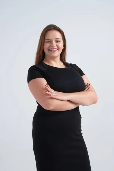 Cheerful girl posing with folded hands against background — Stock Photo, Image