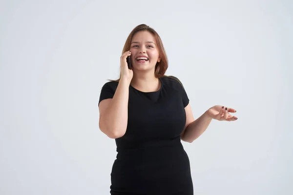 Toothy smiling girl talking on phone at studio — Stock Photo, Image