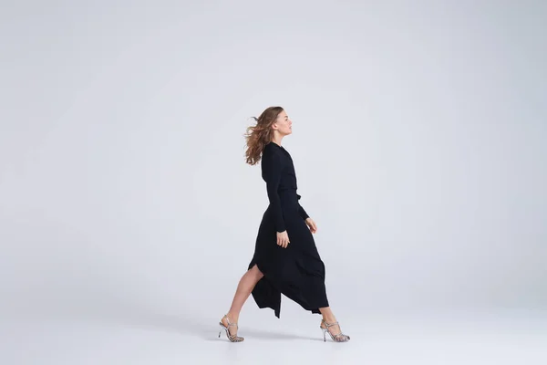 Modelo de mujer caminando en vestido negro tendencia —  Fotos de Stock