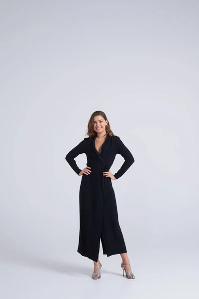 Young beautiful brunette wearing dress posing in studio — Stock Photo, Image