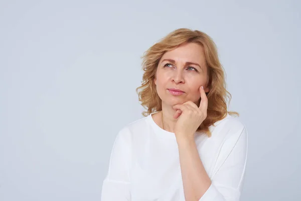 Maturo donna bionda pensando a qualcosa — Foto Stock