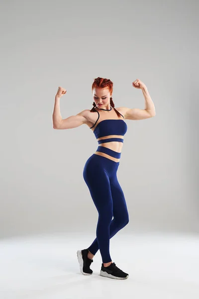 Fit femme en bleu vêtements de sport posant en studio — Photo