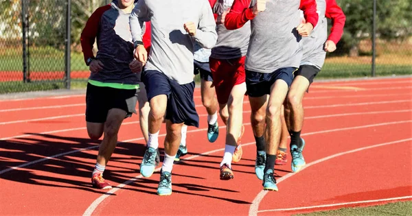 Grupo de chicos corriendo en una pista — Foto de Stock