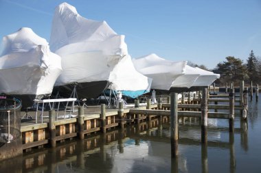 Boats shrin wrapped and stored for winter clipart
