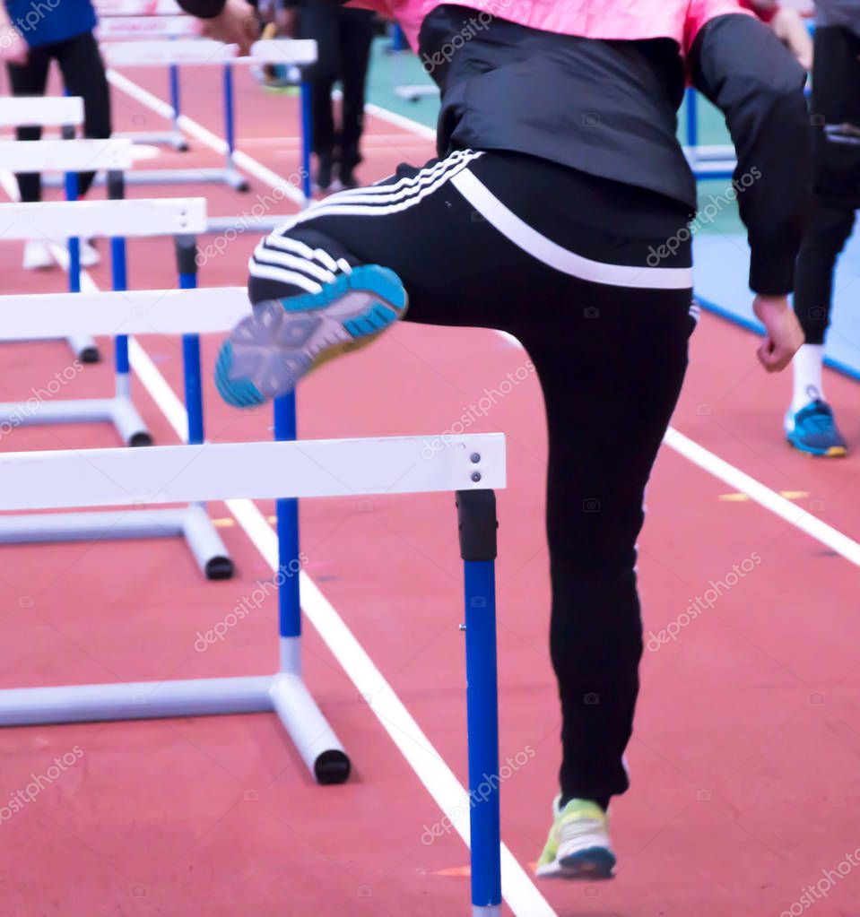 An athlete doing hurdle drills indoor — Stock Photo © WoodysPhotos