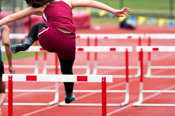 High School Girls Track hurdle race from behind — Stock Photo, Image