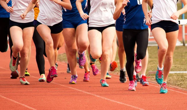 Middelbare schoolmeisjes op een track racing — Stockfoto