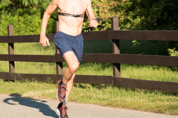 Male runner with heart rate monitor strap