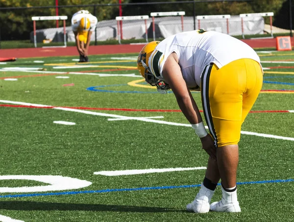 Football players stretching before a game