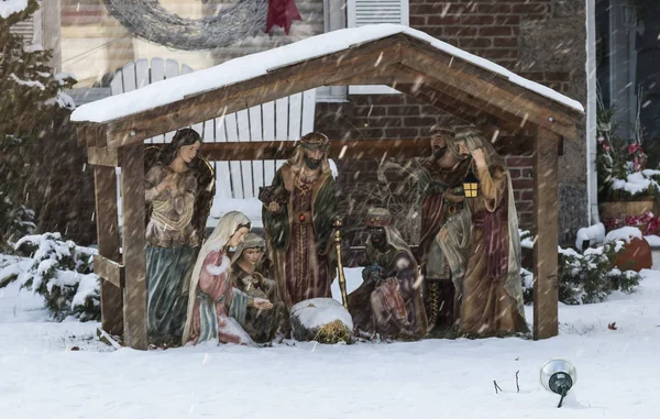 A nativity scene outside during a snow storm