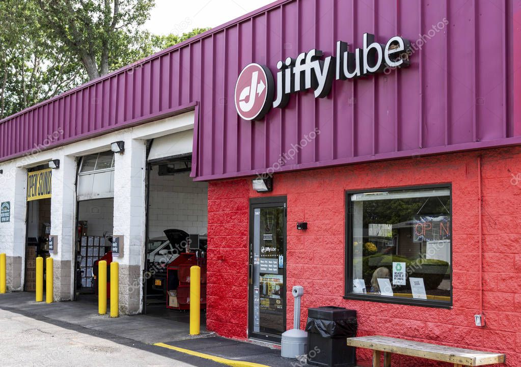 Deer Park, New York, USA - 12 June 2019: Three bay doors are open nest to the waiting room of a jiffy lube oil change building.
