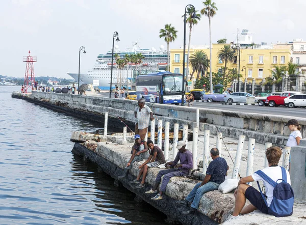 Mensen die op cementmuren zitten te vissen bij de Malecon in Havana C — Stockfoto