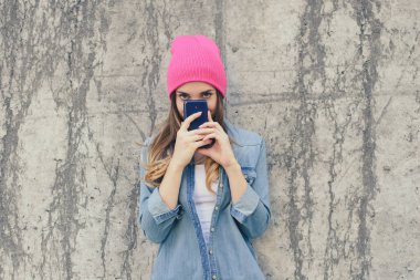 Şüpheli ya da utangaç kadın rahat kıyafetler ve gizleme o pembe şapka
