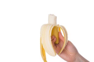 Close up photo of hand holding peeled and bitten banana isolated over white background clipart