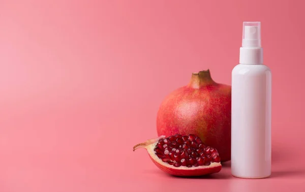 Pampering advertising creative concept. Panoramic photo of aerosol plastic pump container of cleanser tonic toner wash bath with pomegranate aroma isolated over pastel background empty blank space