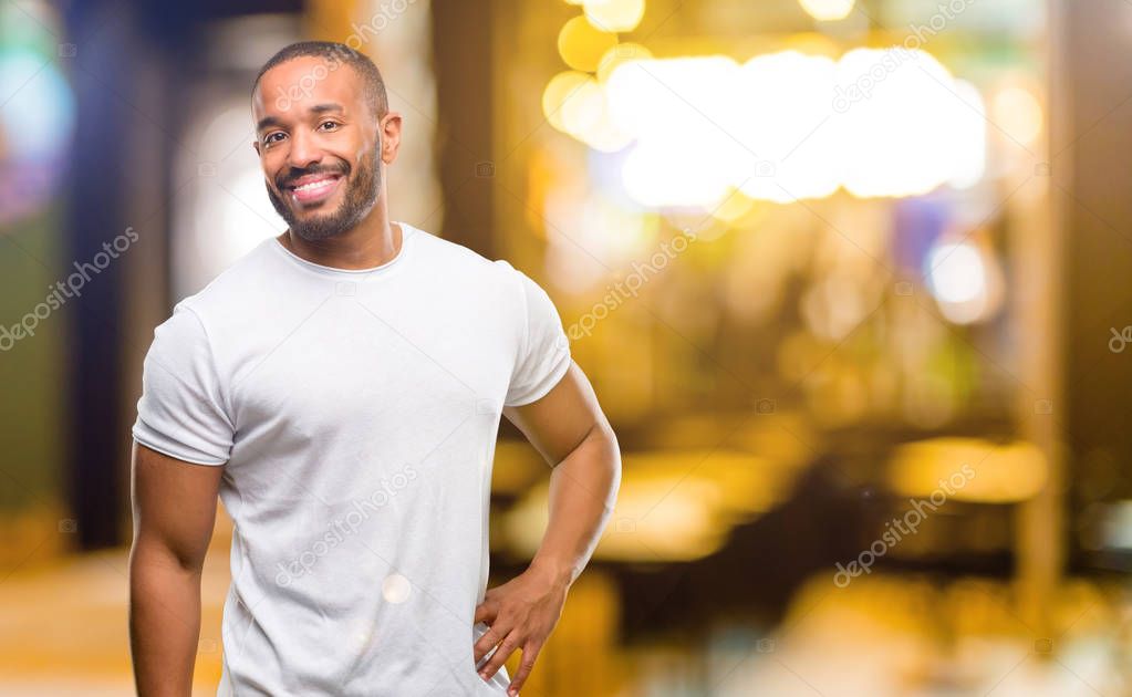 African american man with beard confident and happy with a big natural smile laughing at night