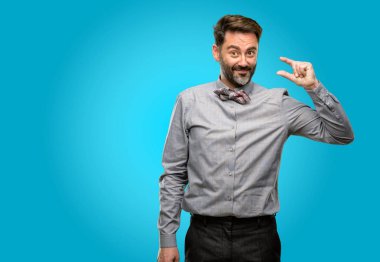 Orta yaş adam, sakal ve çok küçük bir şey, holding papyon büyüklük kavramı
