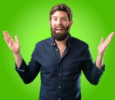Mutlu ve ifade wow jest yeşil arka plan üzerinde tezahürat büyük sakallı genç hipster adam