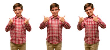 Handsome toddler child with green eyes smiling broadly showing thumbs up gesture to camera, expression of like and approval clipart