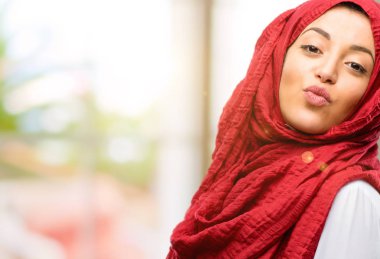 Genç Arap kadın giyiyor hijab ifade aşk, darbeler öpücük kamerasına, flört