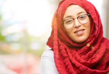 Kendinden emin ve mutlu bir büyük doğal gülümseme gülmüyorum, doğal ifade ile hijab giyen genç Arap kadın