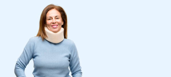 Injured woman wearing neck brace collar confident and happy with a big natural smile laughing isolated blue background