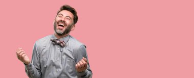 Orta yaş adam, sakal ve papyon kendinden emin ve mutlu bir büyük doğal ile smile gülüyor