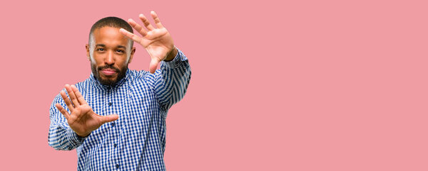 African american man with beard confident and happy showing hands to camera, composing and framing gesture