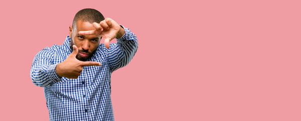 African american man with beard confident and happy showing hands to camera, composing and framing gesture