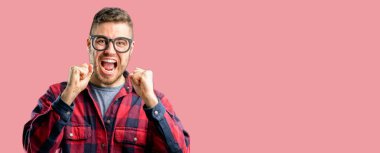 Genç yakışıklı adam mutlu ve heyecanlı kazanan jest ifade. Başarılı ve zafer, zafer kutluyor