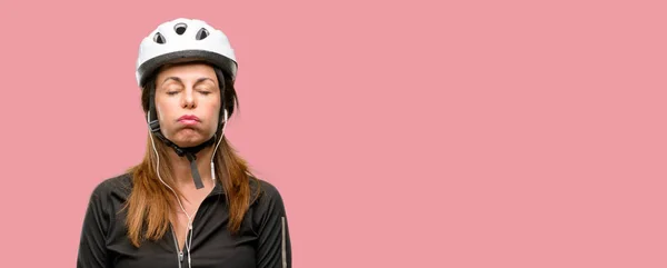 中年サイクリスト女性眠そうな表情 酷使され 疲れでイヤホンを使用して — ストック写真