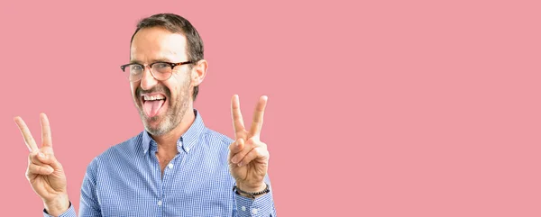 Handsome Middle Age Man Looking Camera Showing Tong Making Victory — Stock Photo, Image