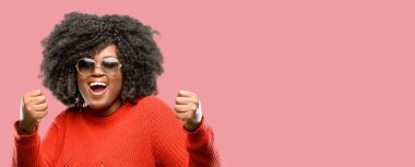 Büyük başarı, güç, enerji ve olumlu duygular ifade güzel Afrikalı kadın mutlu ve heyecanlı kutluyor zafer. Yeni iş neşeli kutluyor