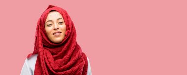 Kendinden emin ve mutlu bir büyük doğal gülümseme gülmek ile hijab giyen genç Arap kadın
