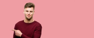 Uzak yan parmak ile işaret yakışıklı genç