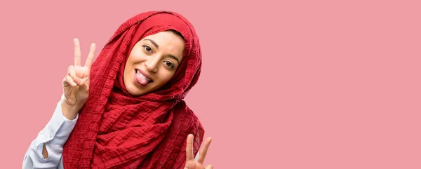 Young Arab Woman Wearing Hijab Looking Camera Showing Tong Making — Stock Photo, Image