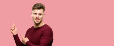 Uzak yan parmak ile işaret yakışıklı genç