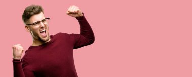 Büyük başarı, güç, enerji ve olumlu duygular ifade yakışıklı genç adam mutlu ve heyecanlı kutluyor zafer. Yeni iş neşeli kutluyor