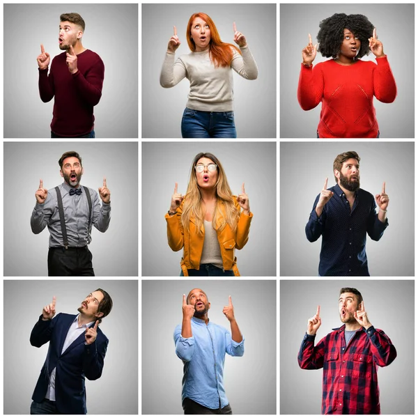 Group of mixed people, women and men happy and surprised cheering expressing wow gesture pointing up