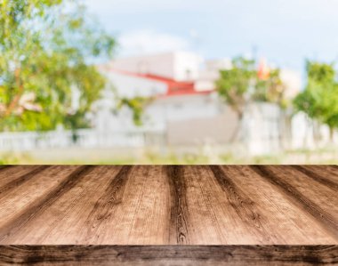 Wooden empty table board in front of blurred background. Can be  clipart