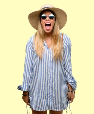 Bıkkın ve hayal kırıklığına uğramış bağırarak genç kadın güneş gözlüğü ve stresli, panik, korku içinde yaz şapka giyiyor. Hoş bir jest. İş sataşmak beni çıldırtıyor