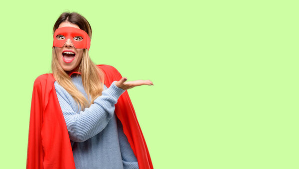 Young super woman holding something in empty hand