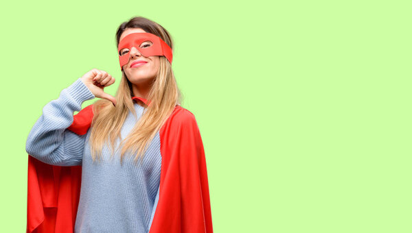 Young super woman proud, excited and arrogant, pointing with victory face
